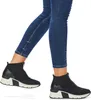 A person wearing blue jeans and black high-top sneakers. Produktbild-Vorschau