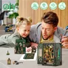 A father and daughter are looking at a DIY book nook model. Náhled obrázku produktu