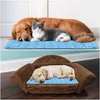 A collage of two images showing pets resting on cooling mats. The top image shows a golden retriever and a cat on a blue mat. The bottom image shows a puppy on a blue mat in a brown pet bed. Produktbild-Vorschau