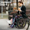 A woman sits on a park bench with a folding electric bike next to her, holding a coffee cup and phone. Produktbild-Vorschau