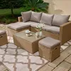 A sectional outdoor furniture set with a coffee table on a patio. Produktbild-Vorschau