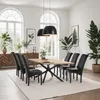A dining room with a wooden table and chairs, set up for a meal. Produktbild-Vorschau