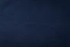 A close-up, textured view of a dark blue fabric. Produktbild-Vorschau