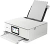 A white Canon PIXMA TS8751 WLAN-Farb-Multifunktionsfotodrucker is shown from a diagonal front-side angle on a white background. The printer has a touchscreen display and paper loaded in the input tray. Podgląd zdjęcia produktu