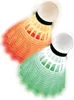 Two illuminated badminton shuttlecocks, one orange and one green, are shown against a white background. Produktbild-Vorschau