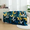 A teal blanket with a gold and white butterfly pattern is draped over a sofa. Produktbild-Vorschau