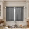A kitchen sink area with dark gray sheer curtains hanging over a window. Produktbild-Vorschau