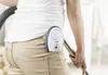 A person is vacuuming while wearing a baby monitor clipped to their pants. Produktbild-Vorschau