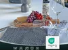 A table setting with grapes, cheese, wine, and glasses, featuring a dish towel. Produktbild-Vorschau
