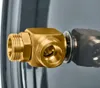 A close-up view of a brass fitting attached to a larger metallic object, with a washer visible. Produktbild-Vorschau