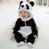 A baby wearing a panda costume sits on a light-colored surface. Produktbild-Vorschau
