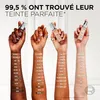 Four arms displaying different shades of foundation on swatches. Voir les images du produit