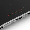 A close-up view of a modern induction cooktop with illuminated digital controls and a metallic trim. Produktbild-Vorschau