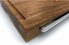 A close-up view of a wooden cutting board with a stainless steel drip tray. Produktbild-Vorschau