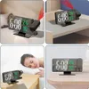 A collage of four images showing a digital projection alarm clock in different settings, including on a nightstand, on a shelf, and next to a sleeping person. Produktbild-Vorschau