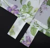 A close-up view of a floral patterned sheer curtain with fabric loops. Produktbild-Vorschau