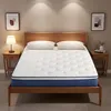 A mattress on a wooden bed frame, with two pillows and two bedside tables with lamps and decorative items. Produktbild-Vorschau