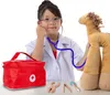 A young girl dressed as a doctor plays with a toy doctor's kit, examining a stuffed animal. Anteprima dell’immagine prodotto