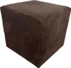 A single, dark brown, corduroy cube-shaped ottoman is shown against a white background.