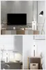 Collage of three lifestyle shots showing a white humidifier/diffuser in different home settings: on a TV stand, on a desk by a window, and on a nightstand. Náhled obrázku produktu