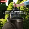A hand is holding a full black trash bag over an open black trash can. Podgląd zdjęcia produktu