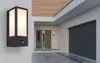 A modern house exterior with a garage door, front door, and an outdoor light fixture. Anteprima dell’immagine prodotto
