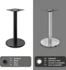 Two table bases, one black and one silver, are shown side-by-side against a split background. Below each base is a swatch indicating its color and material in multiple languages. Produktbild-Vorschau