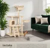 A cat tree and a green sofa in a living room setting. Náhled obrázku produktu