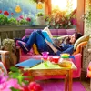 A woman reads a book on a balcony with a cat on her lap, surrounded by plants and flowers, with a teapot and cup on a table. Produktbild-Vorschau