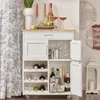 A white kitchen cart stocked with wine bottles and glassware, set against a backdrop of a toile-patterned curtain and decorative wall hangings. Produktbild-Vorschau