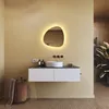 A modern bathroom vanity with a sink, mirror, and accessories. Produktbild-Vorschau