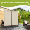 An outdoor patio scene with a beige room divider set up, featuring outdoor furniture and lush greenery in the background. Náhled obrázku produktu
