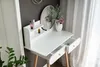 A white vanity table with a mirror and drawers, decorated with flowers and cosmetics. Anteprima dell’immagine prodotto