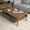 A coffee table with two cups of coffee and a newspaper on it, placed in a living room setting next to a sofa and a TV stand. Náhľad obrázku produktu