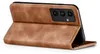 A brown leather flip case for a smartphone is shown from a side angle, with the phone partially inserted and the cover open. Produktbild-Vorschau