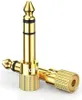 Two gold-colored audio adapters are shown against a white background. Podgląd zdjęcia produktu