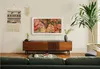 A living room scene with a Samsung TV displaying artwork above a wooden media console. Voir les images du produit