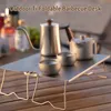 A foldable titanium barbecue desk with camping cookware on a wooden table. Náhled obrázku produktu
