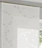 A close-up view of a white sliding curtain with a gray dotted pattern. Produktbild-Vorschau