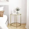 A bedside table next to a bed, with a vase of flowers and a framed picture on top. Náhľad obrázku produktu