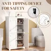 A white bathroom cabinet with its doors open, displaying shelves with toiletries and towels. The image also includes inset diagrams illustrating an anti-tipping device for safety. Produktbild-Vorschau