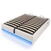 A white bed frame with a slatted mattress support and blue LED lighting around the base, shown against a white background. Produktbild-Vorschau