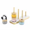 A wooden stacking toy with rings and a zebra figure, set against a white background. Produktbild-Vorschau