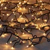 A close-up view of a string of warm white LED lights on a dark, textured surface. Produktbild-Vorschau