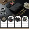 A flat lay arrangement of a wallet, cards, coins, money, earphones, and a key. Produktbild-Vorschau