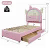 A pink children's bed with a unicorn-themed headboard and two drawers is shown with dimensions indicated. Produktbild-Vorschau
