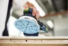 A person is using a sander on a wooden surface. Voir les images du produit