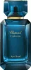 A product shot of a blue glass perfume bottle with gold accents. Podgląd zdjęcia produktu