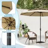 A patio scene with a beige umbrella and chairs. Anteprima dell’immagine prodotto