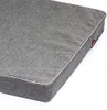 A close-up view of a gray dog mattress with white piping. Produktbild-Vorschau